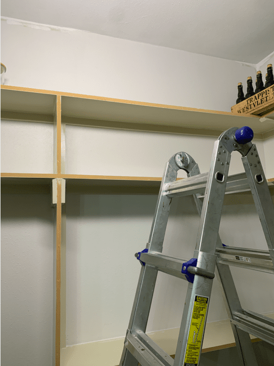 Ripping off the old trim on the shelves.