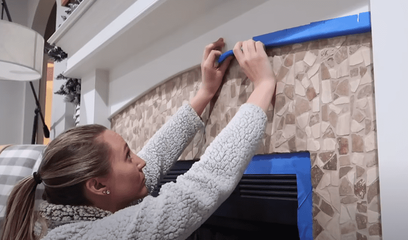 Painting stone fireplace ideas. Taping off the edges of the stone fireplace. Prepping it for chalk paint. 