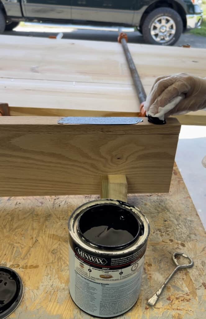 staining wood shelf.