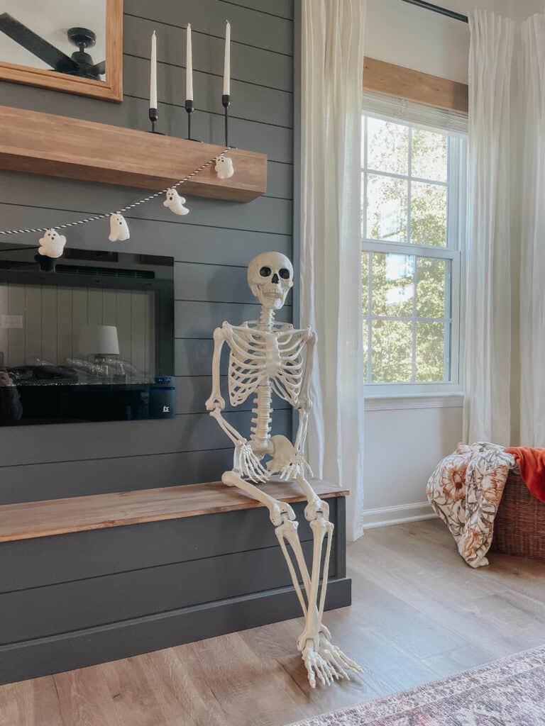 Skeleton sitting by the window.