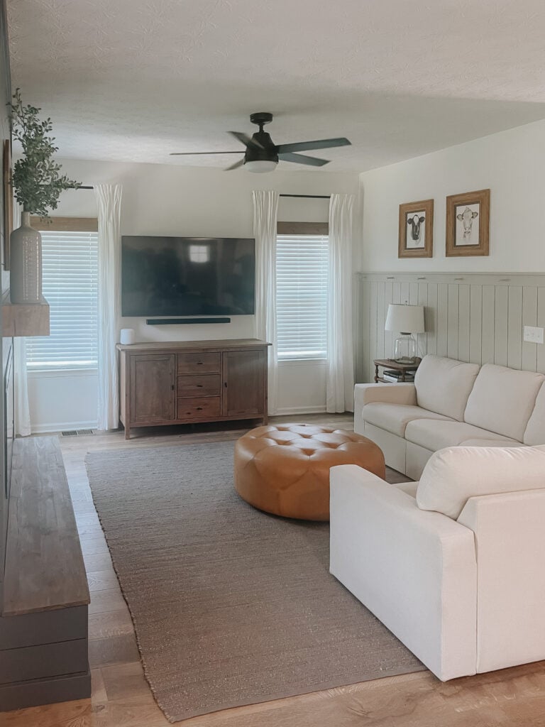 Living room with wooden window valance. 