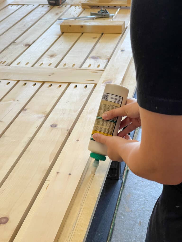Adding wood glue to table build. 