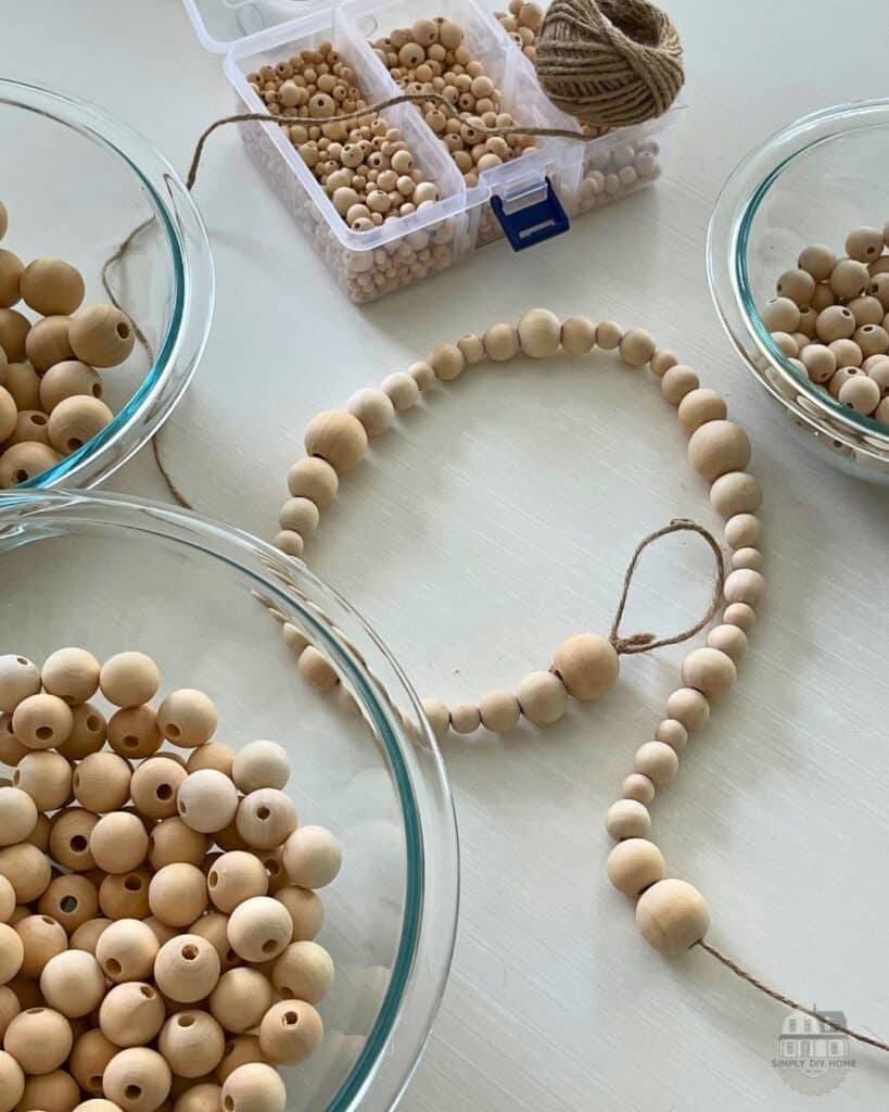 Stringing wood beads on to twine.